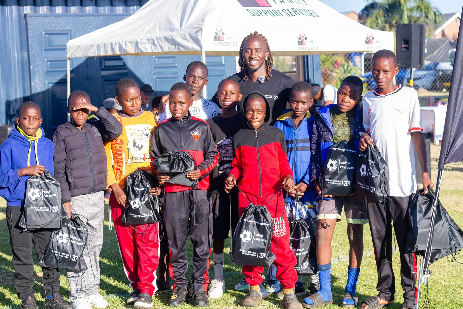 Young people receiving support packs from the foundation